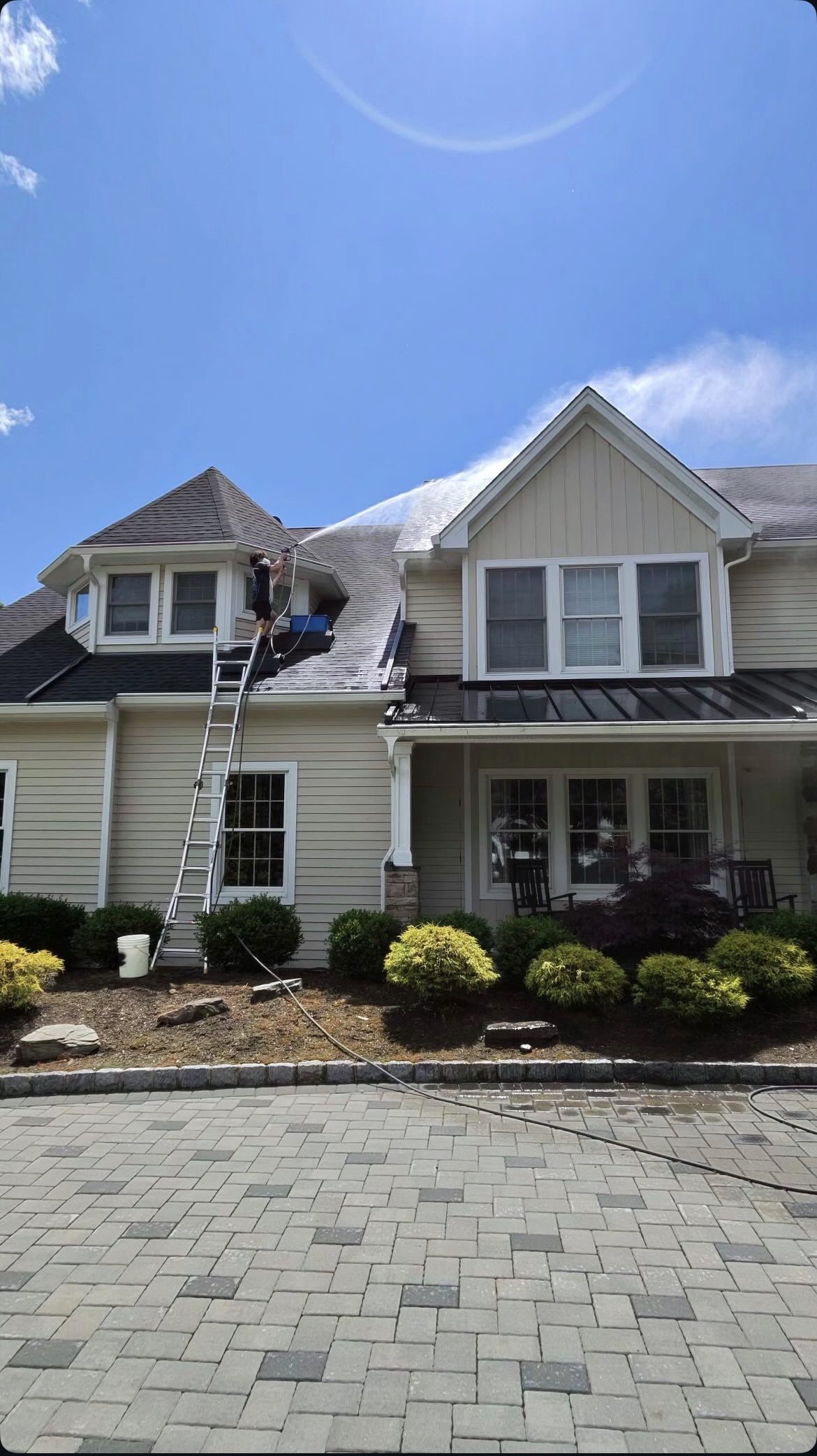 Pure Blue technician soft washing a large North Jersey home