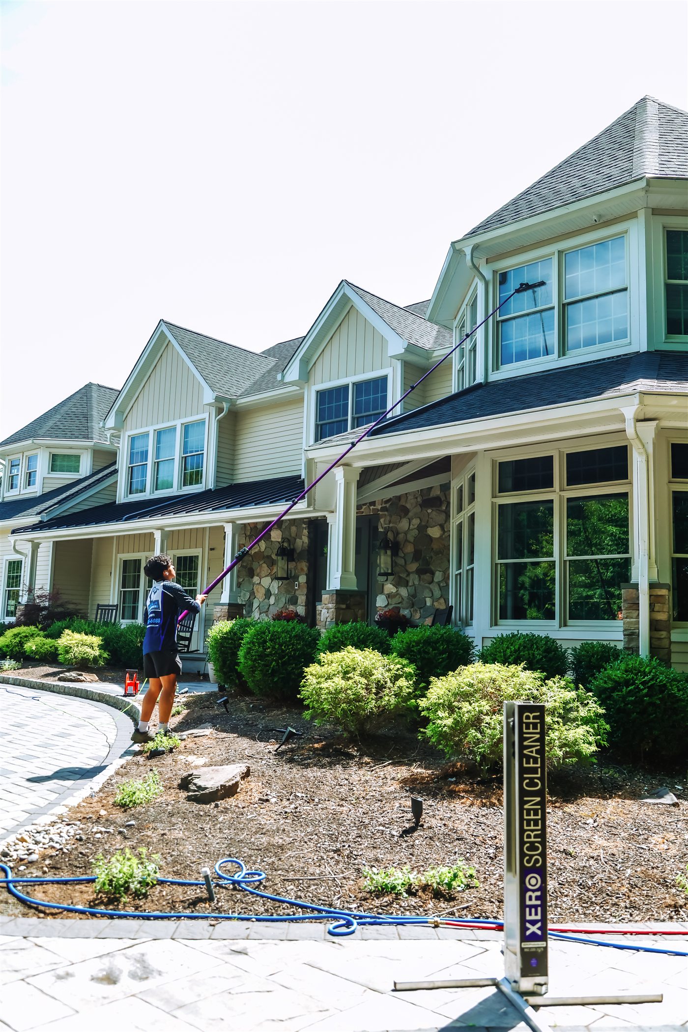 Pure Blue technician completing professional window cleaning