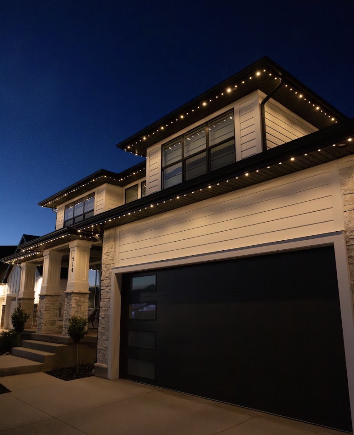 Warm white permanent LED lights following the eaves of a modern home