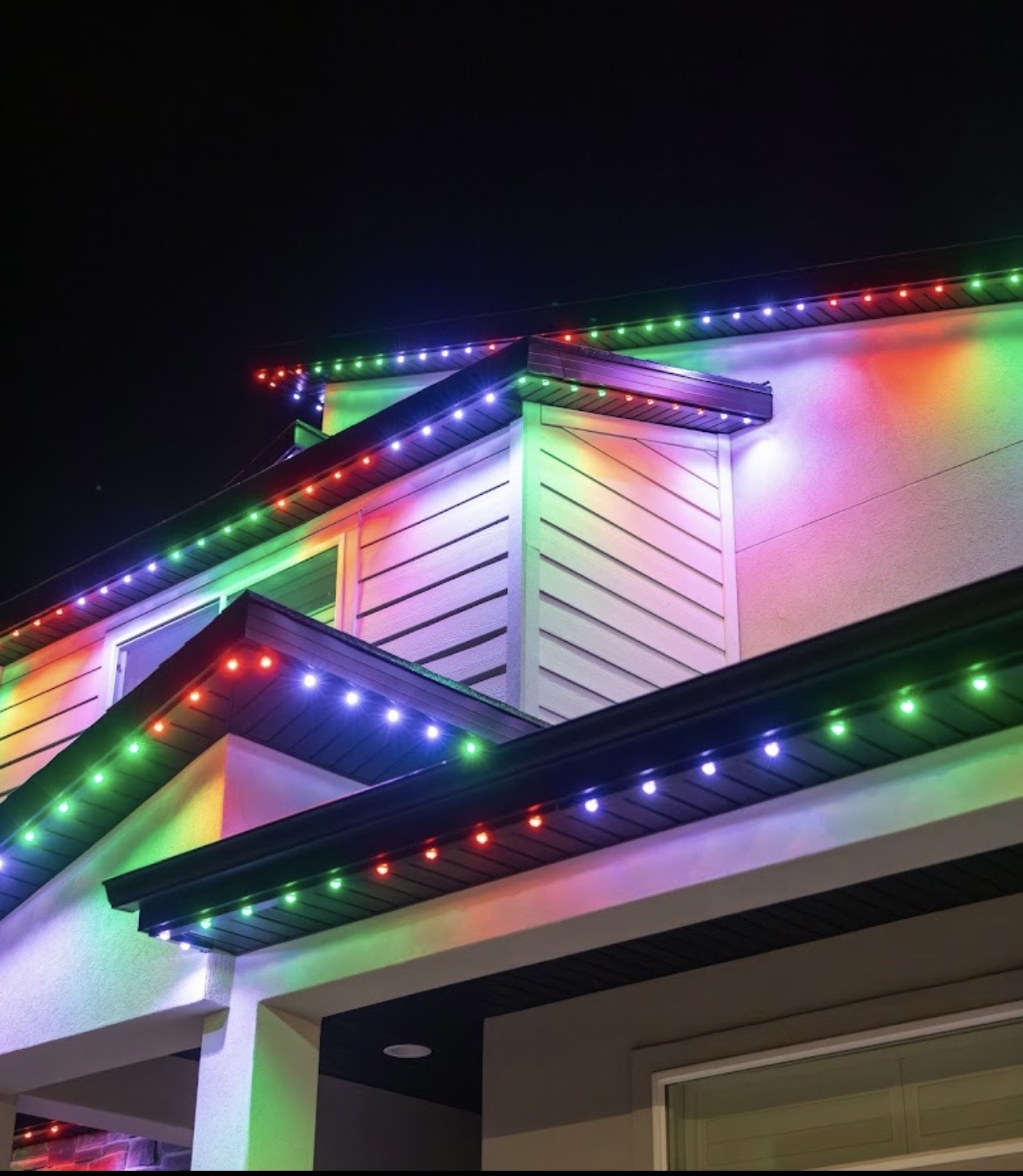 Close view of red green and white permanent LEDs under residential eaves